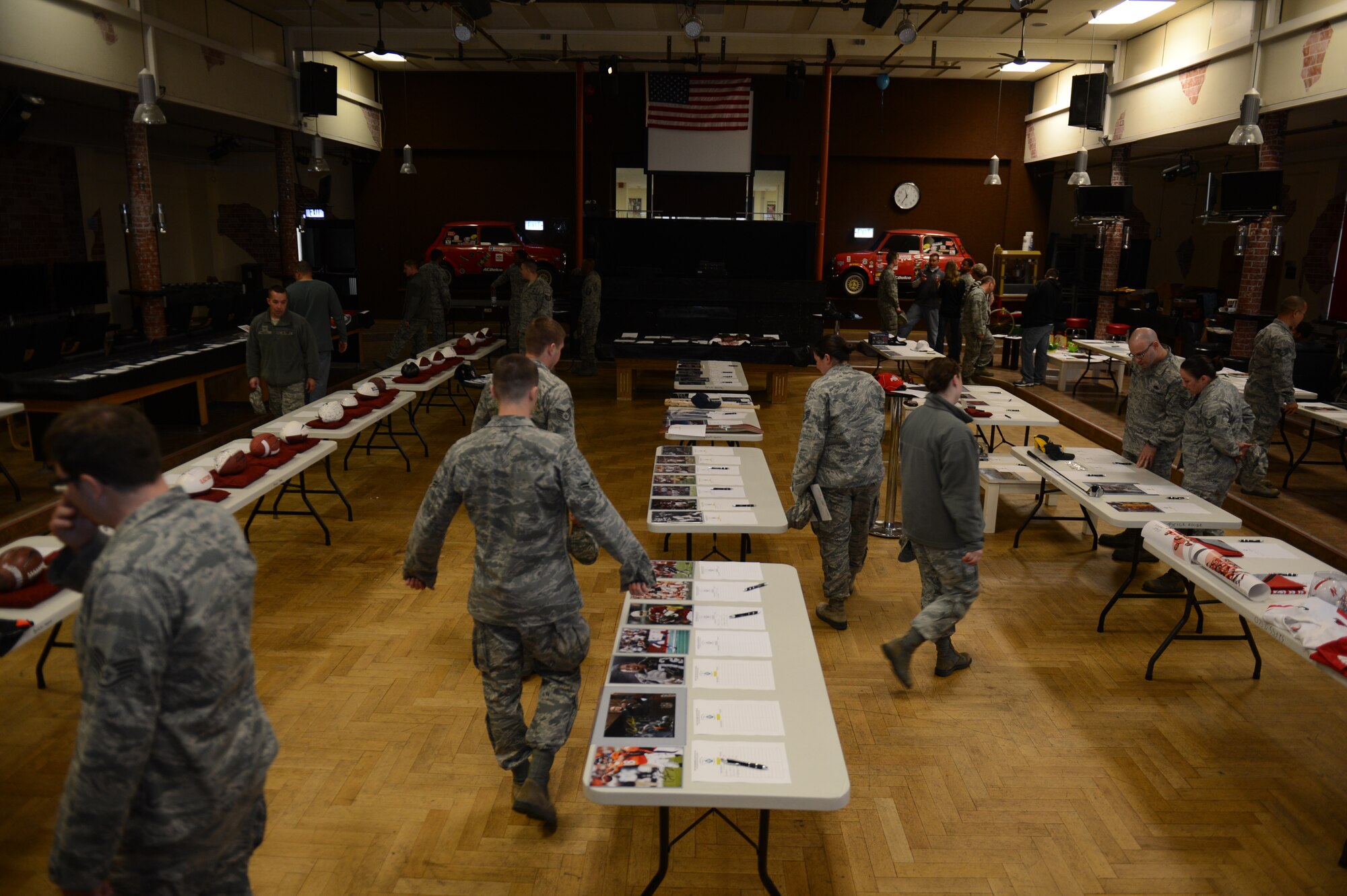 SPANGDAHLEM AIR BASE, Germany – Airmen attend a silent auction at the Brick House May 31, 2013. U.S. Air Force Master Sgt. Anthony Mitchell, 52nd Logistics Readiness Squadron assistant first sergeant and Spangdahlem First Sergeant Council fundraising chairperson collected more than 150 items to be sold at the event to support Operation Warm Heart. (U.S. Air Force photo by Airman 1st Class Gustavo Castillo/Released)