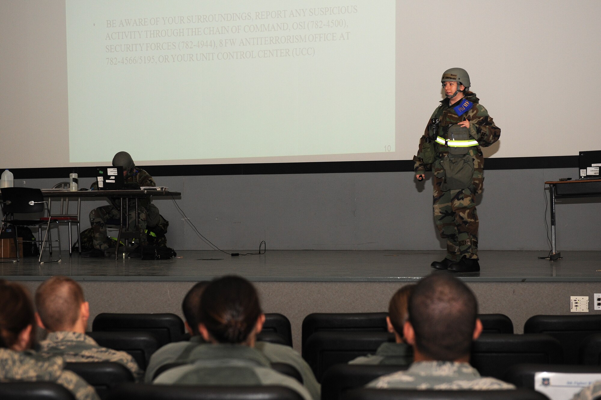 Staff Sgt. Kristie Stefinsky, 8th Force Support Squadron personnel deployment reception function member, briefs follow on forces role-players regarding emergency procedures during exercise Beverly Bearcat 13-01 at Kunsan Air Base, Republic of Korea, April 8, 2013. More than 70 8th Fighter Wing role-players received briefings on base facilities and conditions. (U.S. Air Force photo by Staff Sgt. Jonathan Fowler/Released)