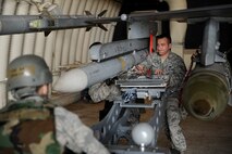 Staff Sgt. Gregory Harrison, 8th Aircraft Maintenance Squadron, right, and Airman 1st Class Jonathan Mahlan, middle, 8th AMXS, push a missile into place during an Operational Readiness Inspection at Kunsan Air Base, Republic of Korea, April 8, 2013. The Airmen quickly got the F-16 Fighting Falcons loaded after the generation order was given. (U.S. Air Force photo by Senior Airman Marcus Morris/Released)