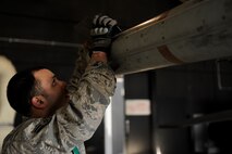 Airman 1st Class Jonathan Mahlan, 8th Aircraft Maintenance Squadron, attaches precision-guiding fins onto a missile during an Operational Readiness Inspection at Kunsan Air Base, Republic of Korea, April 8, 2013. The Airmen were tested on their ability to generate aircraft quickly while following procedures. (U.S. Air Force photo by Senior Airman Marcus Morris/Released)