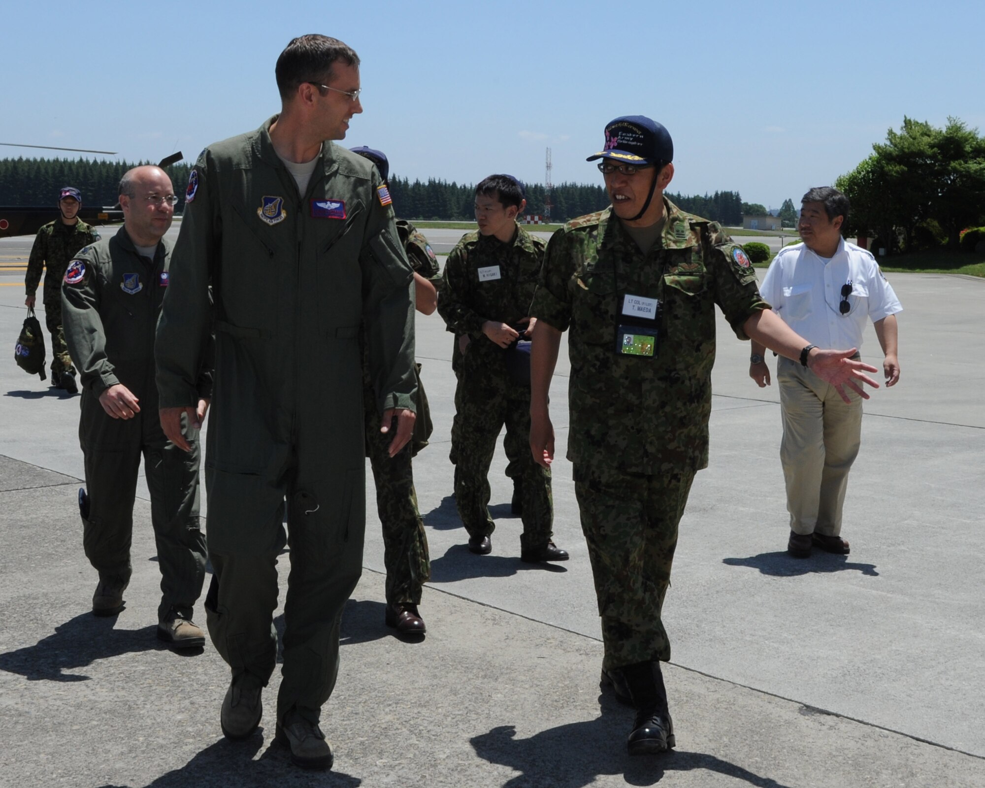 YOKOTA AIR BASE, Japan -- Lt. Col. Corban Spraker (left), 459th Airlift Squadron director of operations, talks with Lt. Col. Takayuki Maeda, Japan Eastern Division Helicopter Group commander, May 31, 2013, at Yokota Air Base, Japan. Maeda and members of the Japan Ground Self-Defense Force at Tachikawa Air Base, Japan, visited Yokota as part of a bilateral partnership event between the units. (U.S. Air Force photo by Senior Airman Desiree Economides)