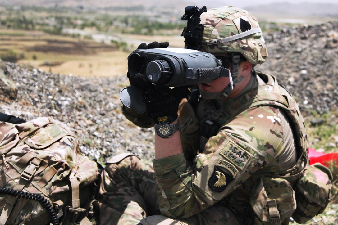 U.S. Army Sgt. Sinclair scans the area with a Lightweight Laser Designator Rangefinder during a meeting with key village elders in Khowst province, Afghanistan, June 02, 2013. Sinclair is assigned to 101st Airborne Division's Company W, 2nd Battalion, 506th Infantry Regiment, 4th Brigade Combat Team.