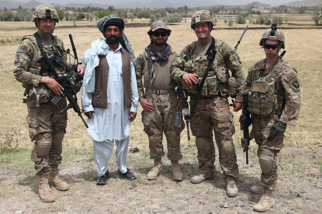 U.S. Army Lt. Col. Larry F. Dillard, left, village elder Mah Mah Azim ...