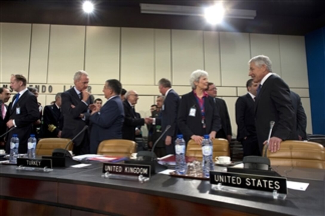 Secretary of Defense Chuck Hagel, right, speaks with United Kingdom’s Permanent Representative Mariot Leslie before the start of a meeting of the North Atlantic Council at NATO headquarters in Brussels, Belgium, on June 4, 2013.  NATO defense ministers will discuss topics including Afghanistan, cyber security, a possible Libya training mission and collective defense.  