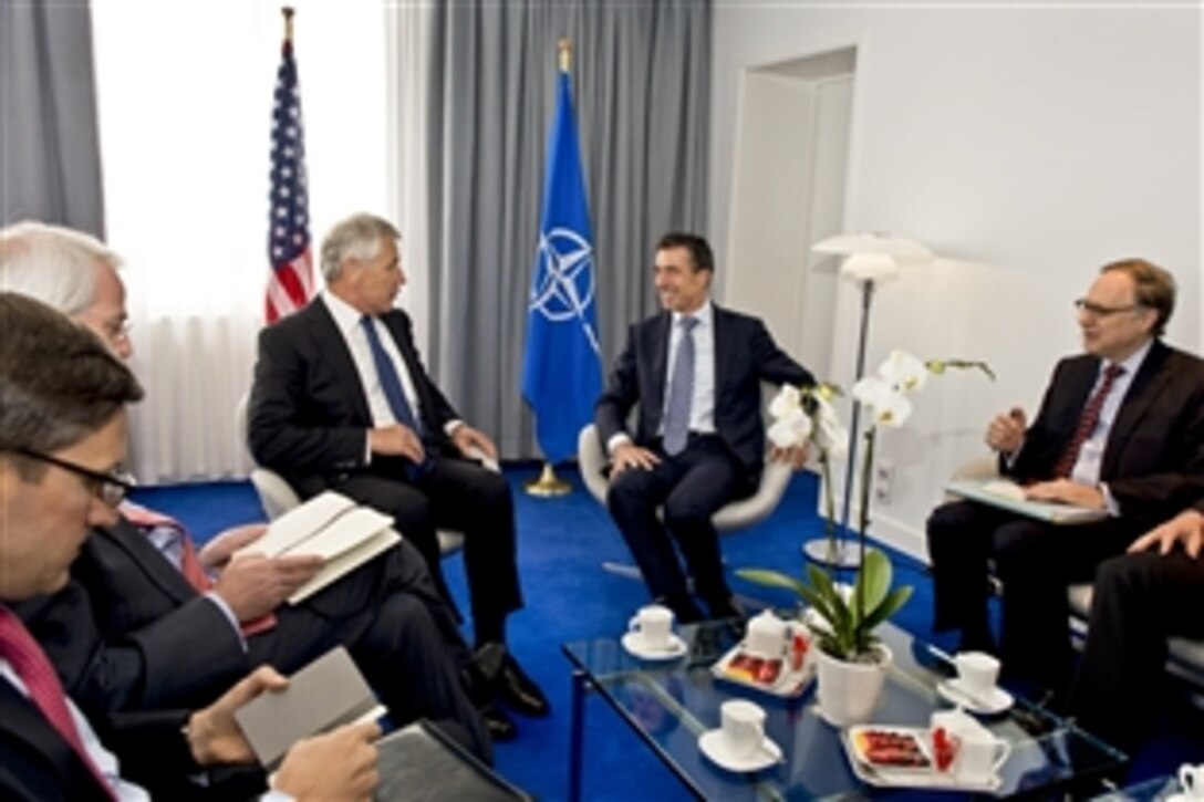 U.S. Defense Secretary Chuck Hagel, left, meets with NATO Secretary General Anders Fogh Rasmussen, right, at NATO headquarters in Brussels, June 4, 2013.