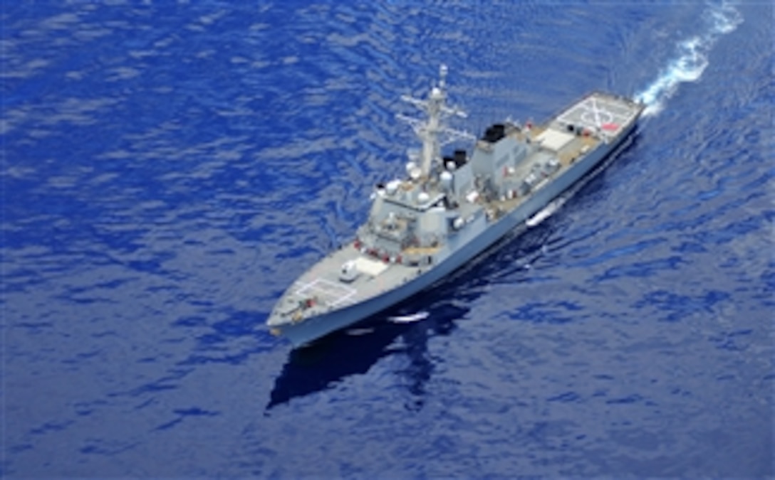 The U.S. Navy guided-missile destroyer USS O’Kane (DDG 77) maneuvers through the azure waters of the Pacific Ocean off the coast of Oahu, Hawaii, on May 21, 2013.  O’Kane is an Arleigh Burke class destroyer.  