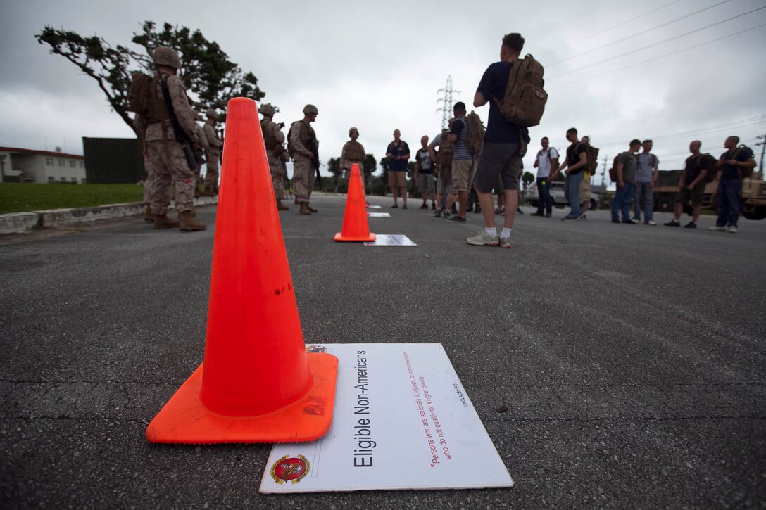 Marines with Combat Logistics Battalion 31, 31st Marine Expeditionary Unit, sort the evacuees by their nationality at an evacuation control center during a non-combatant evacuation operation here, June 3. The NEO exercise processed and evacuated more than 20 role players through the ECC, which is a collection of tents used to search, identify, and process the citizens for transportation out of the dangerous area. The NEO was a part of the 31st MEU’s pre-deployment training for their upcoming patrol. The 31st MEU is the only continuously forward-deployed MEU and is the Marine Corps’ force in readiness in the Asia-Pacific region.