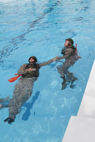 Marines attending the Water Survival Advanced course compete against one another in a run-swim-run event May 23, 2013 at the WaterWorks outdoor pool. This event consisted of Marines practicing each of the three different types of rescue swimming techniques.