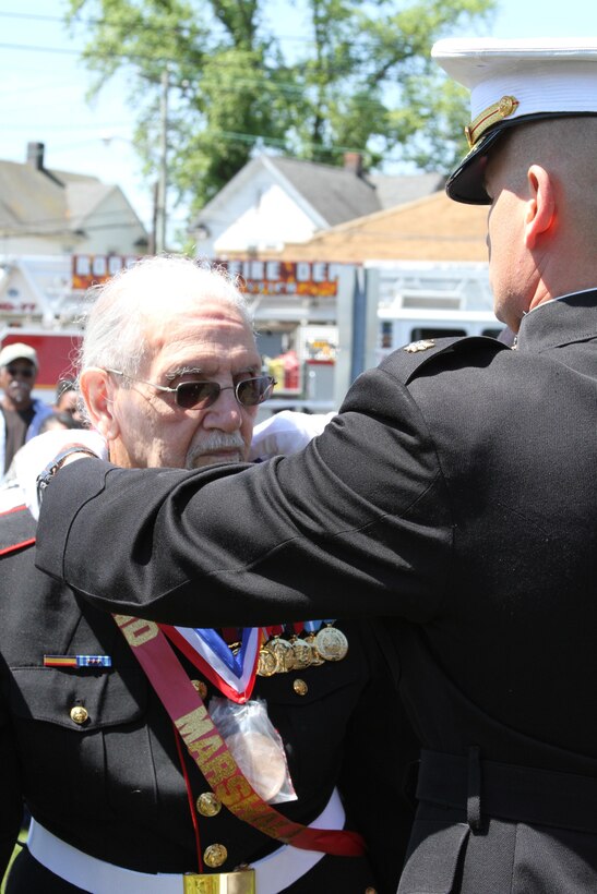 ROOSEVELT, N.Y. -- Robert L. Harding, an original Montford Point Marine, receives a Congressional Gold Medal at the Brig. Gen. George A. Jones Triangle in Roosevelt, N.Y., May 27.  Following his ceremony, a new monument honoring local veterans was unveiled.