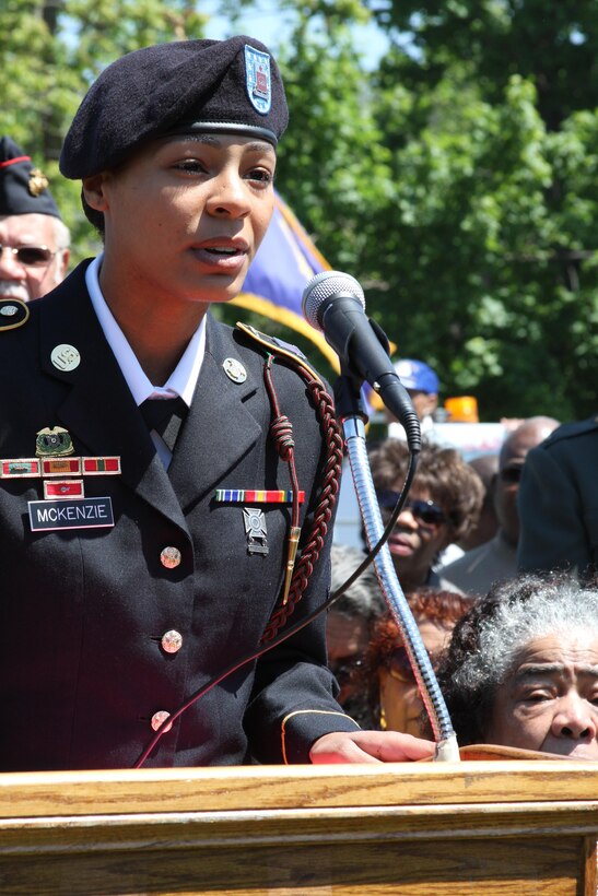 ROOSEVELT, N.Y. - Army Pfc. Brittney McKenzie, who is stationed at Fort Knox, Ky., with 3rd Brigade Combat Team, 1st Infantry Division, 201st Brigade Support Battalion, Alpha Company, addresses the local community during a Congressional Gold Medal ceremony for her grandfather, Robert L. Harding, at Brig. Gen. George A. Jones Triangle in Roosevelt, N.Y., May 27. Harding was being honored for being one of the original Montford Point Marines