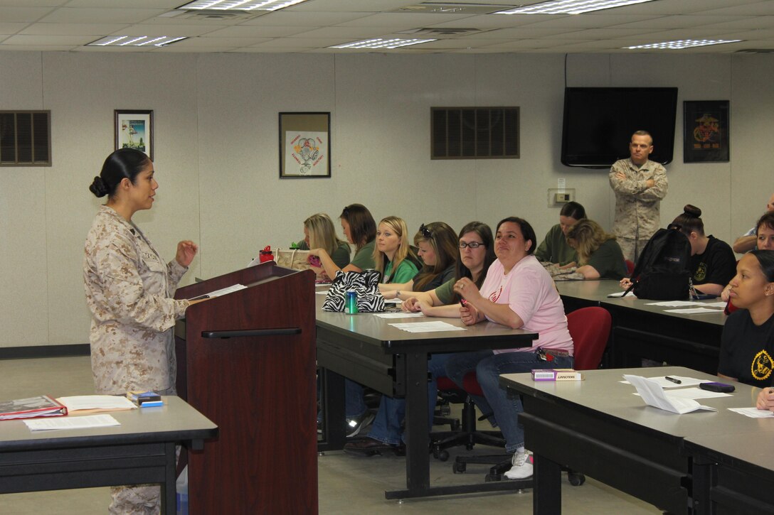 Family Readiness officer, Gunnery Sergeant Nohemi L. Taylor gives the introduction brief to the detachment spouses on Jayne Wayne Day. 