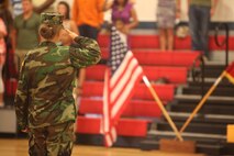 A member of the Young Marines program salutes the colors during the playing of the national anthem during the class’ graduation aboard Camp Lejeune, N.C., June 1, 2013. The program was designed to instill discipline, leadership and teamwork in America’s youth. 