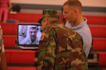 Derik Hernandez (center), a member of the Young Marines program, talks to his father, Master Gunnery Sgt. Socorro Hernandez, through a live video connection following his class’ graduation ceremony aboard Camp Lejeune, N.C., June 1, 2013. Socorro, a mobile logistics chief with Combat Logistics Regiment 2, 2nd Marine Logistics Group, viewed his son’s graduation ceremony from Afghanistan. 