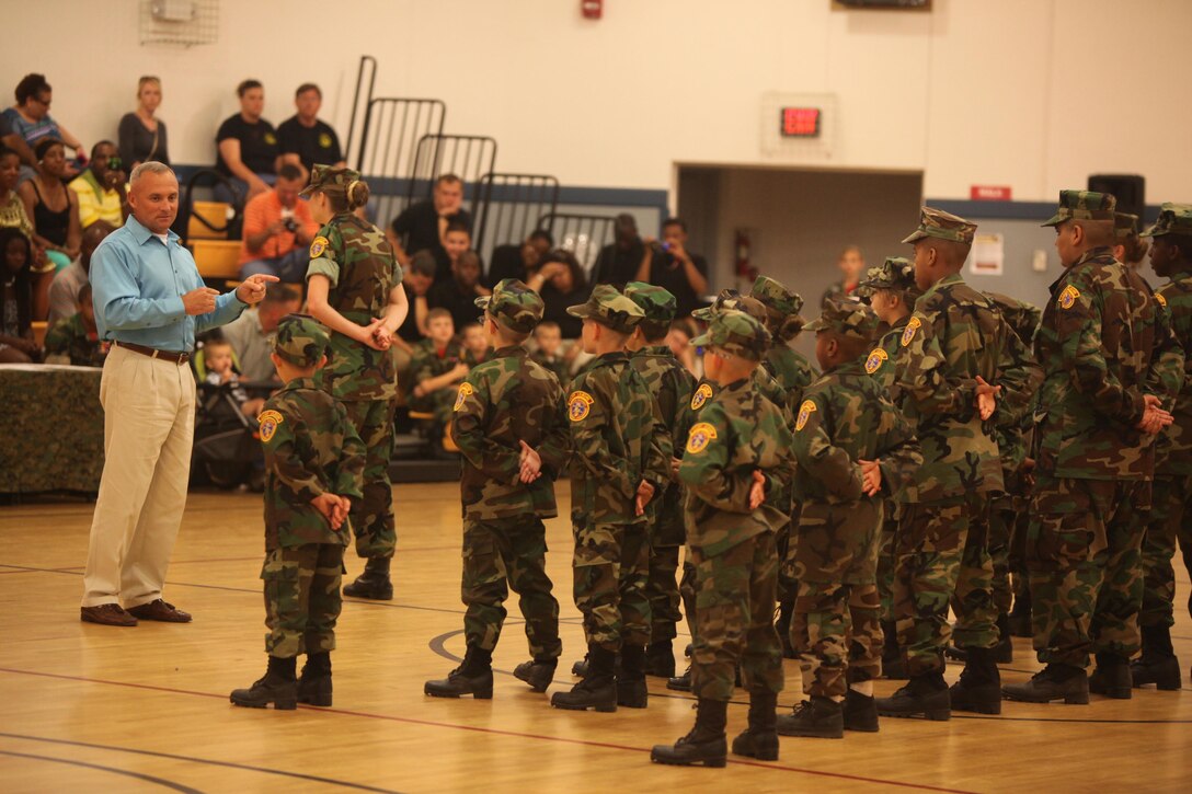 Sgt. Maj. Michael D. Johns (left), the sergeant major of Headquarters Battalion, 2nd Marine Division, speaks to the graduating class of the Young Marines program during the class’ graduation aboard Camp Lejeune, N.C., June 1, 2013. Johns told the graduates about his experiences growing up and in the Marine Corps, and related them to what the Young Marines learned throughout the course of the program. 