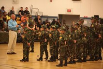 Sgt. Maj. Michael D. Johns (left), the sergeant major of Headquarters Battalion, 2nd Marine Division, speaks to the graduating class of the Young Marines program during the class’ graduation aboard Camp Lejeune, N.C., June 1, 2013. Johns told the graduates about his experiences growing up and in the Marine Corps, and related them to what the Young Marines learned throughout the course of the program. 
