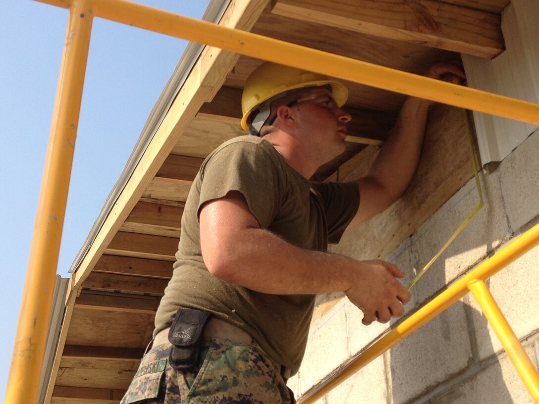 Lance Cpl. David Jerzewski, a combat engineer with Marine Wing Support Squadron 471, Detachment B, measures the gable on a school under construction to apply siding in Orange Walk, Belize during New Horizons 2013.  New Horizons is a U.S. Southern Command exercise that gives U.S., Canadian and Belizean personnel an opportunity to train together in order to better meet future challenges. Personnel are providing medical and dental care, as well as constructing four educational buildings throughout Belize as part of the training. (Official U.S. Marine Corps photo: Courtesy photo//Released)