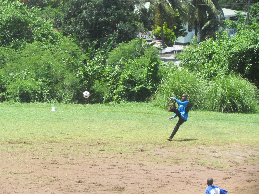 The Goalie for the Boys Training Centre punts the futbol after stopping the team from the U.S. Coast Guard Cutter Oak from scoring a goal. The Boys Training Centre is sponsored by the USAID under the Juvenile Justice Reform Program. USAID’s Juvenile Justice Reform Program seeks to reduce recidivism rates among youth offenders and to increase the chances of youth who have had run-ins with the law to transform themselves into citizens who contribute positively to society. Tradewinds 2013 is a joint, combined exercise conducted in conjunction with partner nations to enhance the collective abilities of defense forces and constabularies to counter transnational organized crime and to conduct humanitarian/disaster relief operations. (Photo courtesy of Mr. Elvin Germain, The Boys Training Centre/Released)