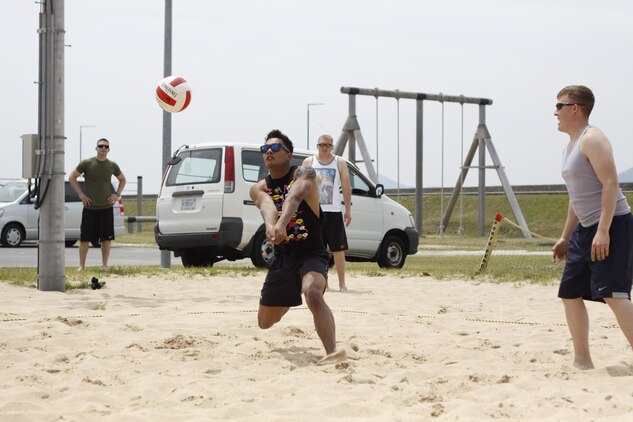 Cpl. Joshua Douglas, Marine Aviation Logistics Squadron 12 mobile facility technician, prepares to bump a serve during the Commander's Cup two-on-two volleyball tournament hosted by IronWorks intramural sports at the outdoor volleyball courts near IronWorks Gym at Marine Corps Air Station Iwakuni, Japan, May 17, 2013.