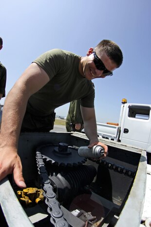 Lance Cpl. Michael Truex, a station aircraft recovery specialist, performs maintenance on an E-28 Emergency Runway Arresting Gear on the flightline, May 24, 2013. Recovery Marines from Iwakuni also currently hold the military-wide record for arrestment landings conducted in less than an hour, performing 13 during Exercise Forager Fury 2012.