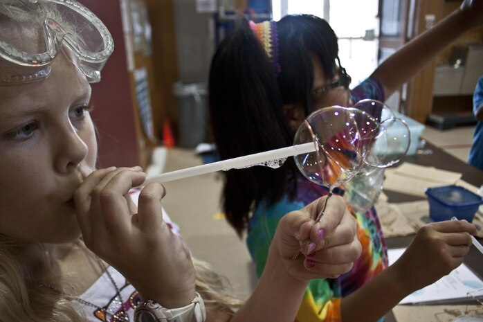 Gabrielle Romeo 8, a Matthew C. Perry Elementary School student, demonstrates her project during the Science, Technology, Engineering and Mathematics Repurpose Carnival, which took place inside the M. C.
Perry Elementary School gymnasium May 31, 2013.
