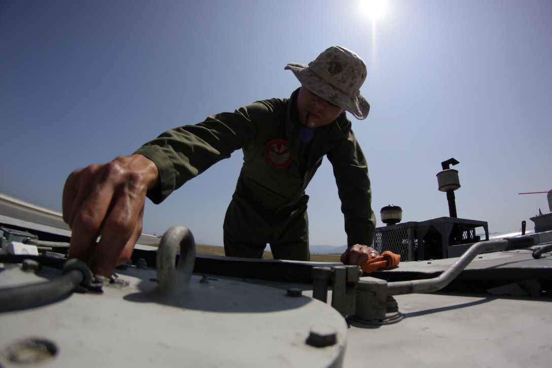 Staff Sgt. Joseph R. Pacheco, a station runway supervisor, performs maintenance on an E-28 Emergency Runway Arresting Gear on the flightline, May 24, 2013. Recovery Marines perform daily maintenance checks, as well as any necessary work after the equipment is used.