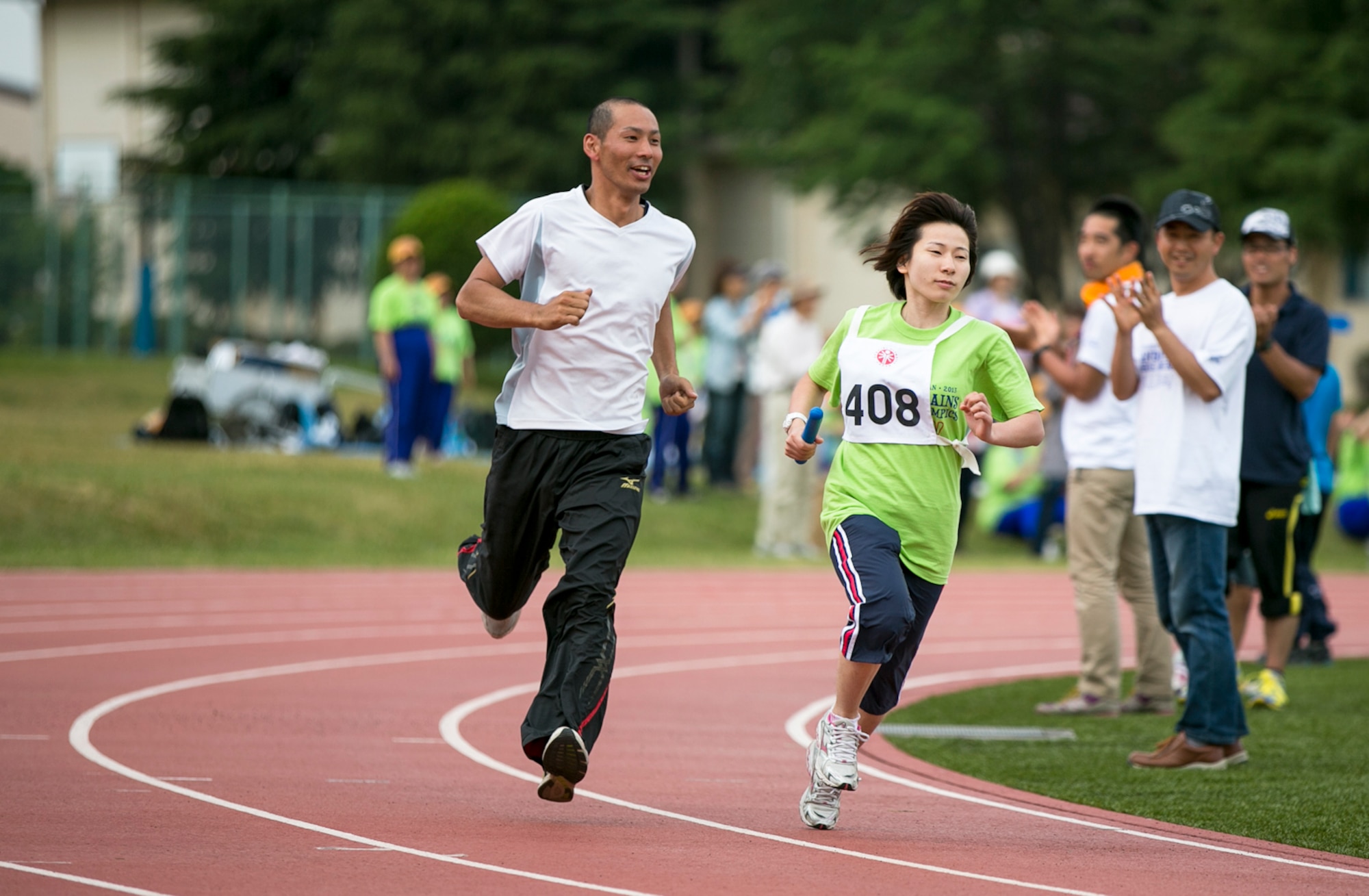 YOKOTA AIR BASE, Japan -- A volunteer runs alongside a Special Olympics athlete during the Kanto Plains Special Olympics held at Yokota Air Base, Japan, June 1, 2013. U.S. Armed Forces, Department of Defense employees and Japanese volunteers joined spectators to assist and encourage more than 150 Special Olympians from around Japan. (U.S. Air Force photo by Airman 1st Class Alexander Archer)
