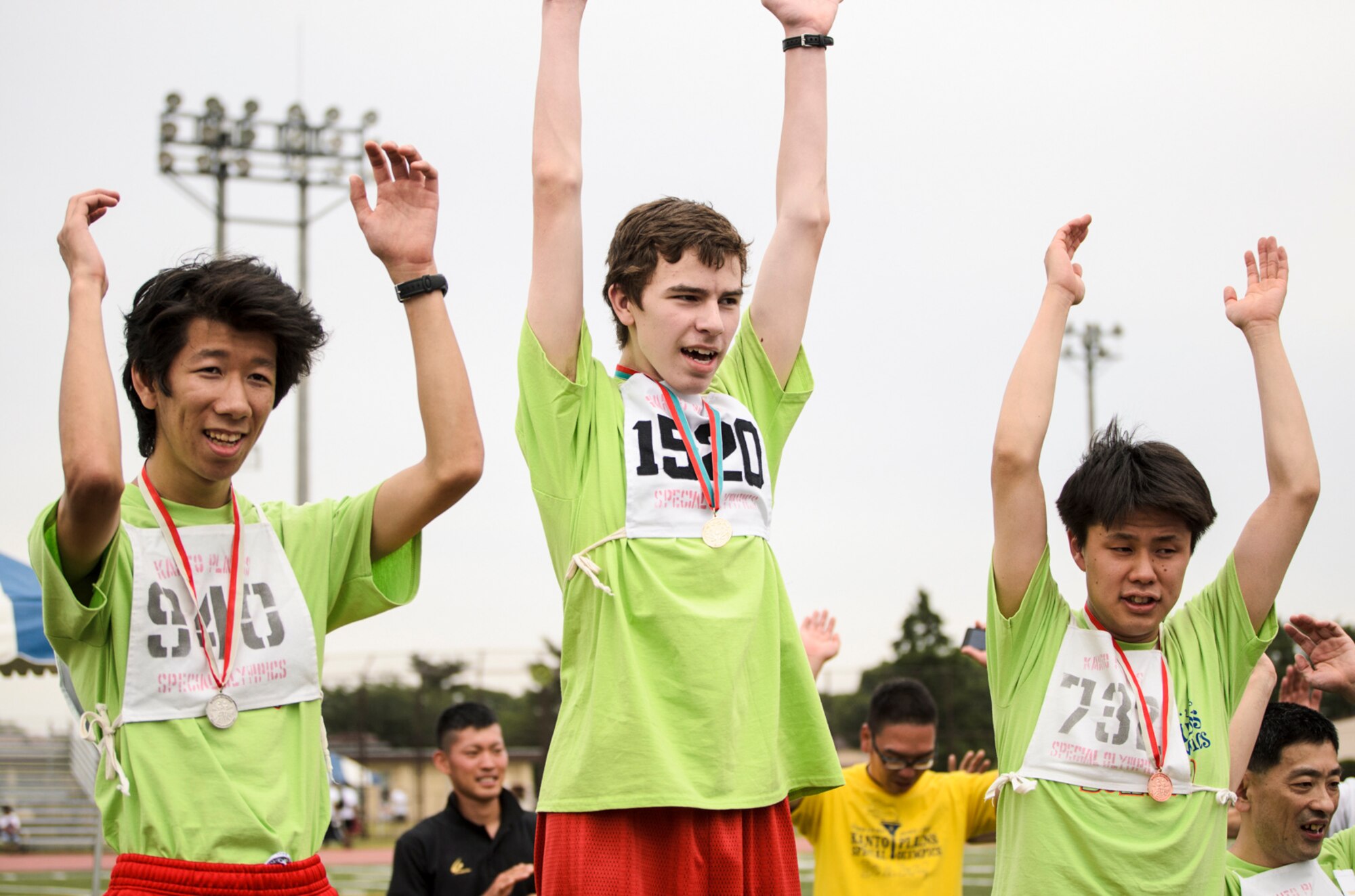 YOKOTA AIR BASE, Japan -- Special Olympic athletes celebrate after receiving metals during the Kanto Plains Special Olympics held at Yokota Air Base, Japan, June 1, 2013. Participants and volunteers participated in a variety of events for this year's 34th annual Special Olympics. (U.S. Air Force photo by Staff Sgt. David Gevert)
