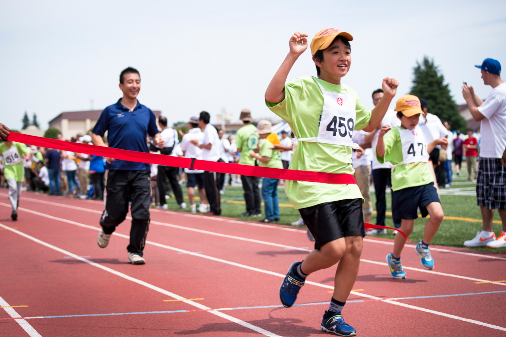 YOKOTA AIR BASE, Japan -- A Special Olympics athlete crosses the finish line during the Kanto Plains Special Olympics held at Yokota Air Base, Japan, June 1, 2013. Additional events during the day included swimming, soccer, basketball and track and field events. (U.S. Air Force photo by Staff Sgt. Asa McQueen)