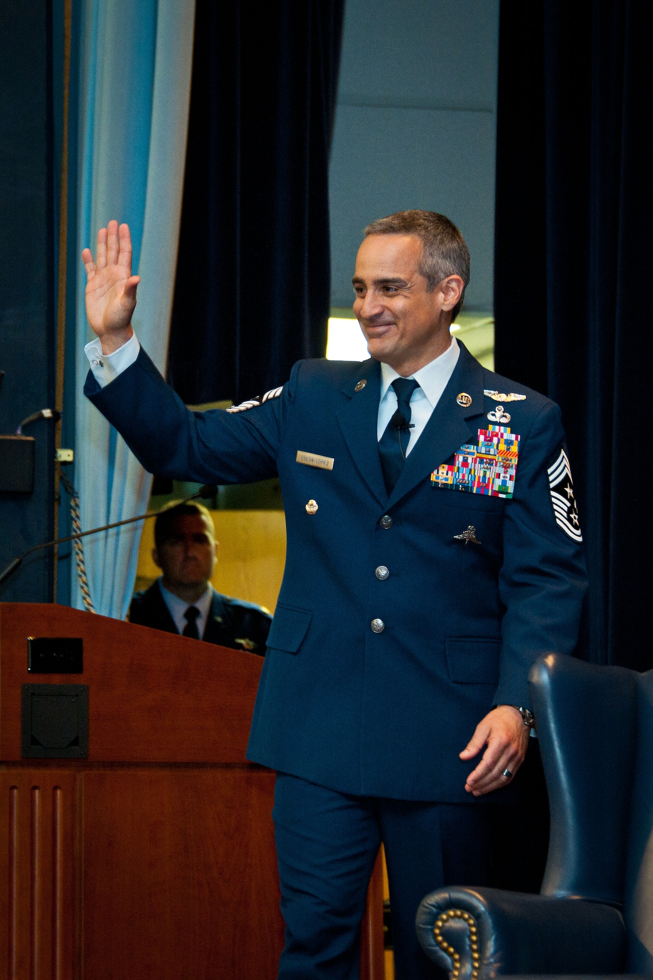 U.S. Air Force Chief Master Sgt. Ramon Colon-Lopez, 18th Wing command chief, greets the audience before his interview during the Gathering of Eagles at Air Command and Staff College, Maxwell Air Force Base, Ala., June 5, 2013. The GoE is ACSC's capstone graduation event. (U.S. Air Force photo by Donna Burnett)