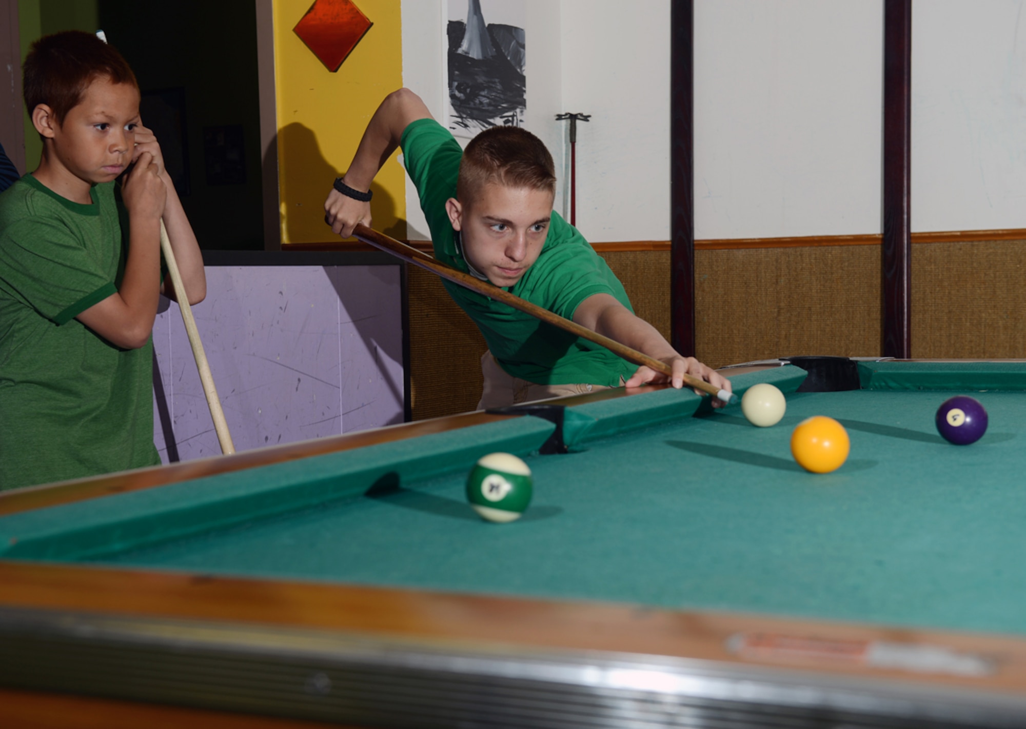 JOINT BASE ELMENDORF-RICHARDSON, Alaska -- . Gage Dabin, 17, plays pool with a Mekhi Womack, 9, at the Kennecott Youth Center June 3. Dabin was awarded the Military Youth of the Year award for his work with youth in Joint Base Elemendorf-Richardson and the Anchorage cummunity. (U.S. Air Force photo/Airman Ty-Rico Lea)