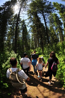 Camp counselors, Michael Anderson Elementary School fourth graders and teachers hike through trees and other parts of the forest May 31, 2013, at YMCA Camp Reed. The 50-minute hike was about 25 minutes up hill and 25 minutes downhill. (U.S. Air Force photo by Senior Airman Earlandez Young/Released)   