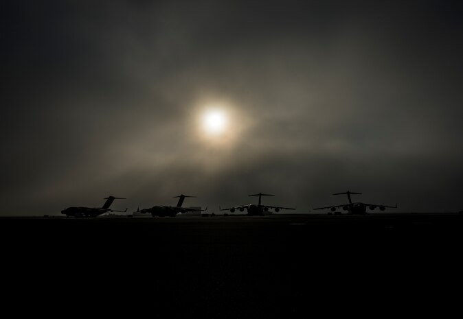 Fog rolls across the Joint Base Charleston flightline as the sun rises above four C-17 Globemaster III’s June 4, 2013, at JB Charleston – Air Base, S.C. The first C-17 to enter the Air Force’s inventory arrived at Charleston Air Force Base in June 1993. The C-17 is capable of rapid strategic delivery of troops and all types of cargo to main operating bases or directly to forward bases in the deployment area. (U.S. Air Force photo/Senior Airman Dennis Sloan)