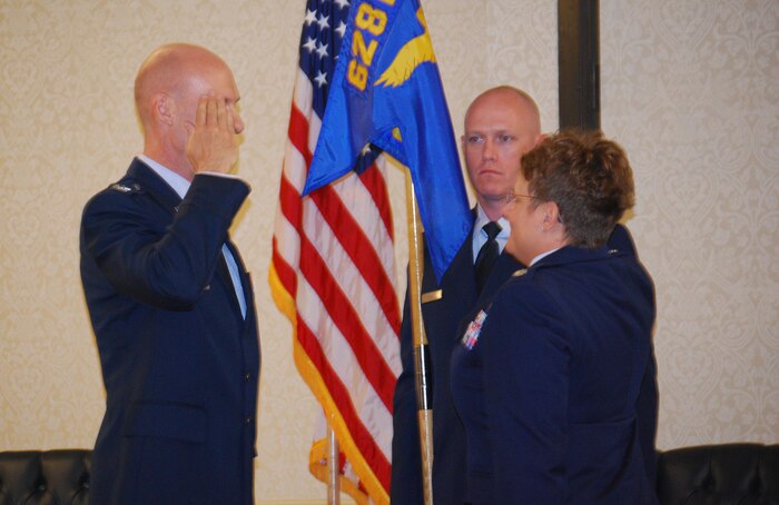 Col. Judith Hughes, 628th Medical Group commander, passes the squadron guidon to Lt. Col. Raymond Clydesdale, incoming 628th Aerospace Medicine Squadron commander, during the 628th AMDS  change of command ceremony June 3, 2013, at Joint Base Charleston – Air Base, S.C. (U.S. Air Force photo/Airman 1st Class Jasmonet Jackson) 