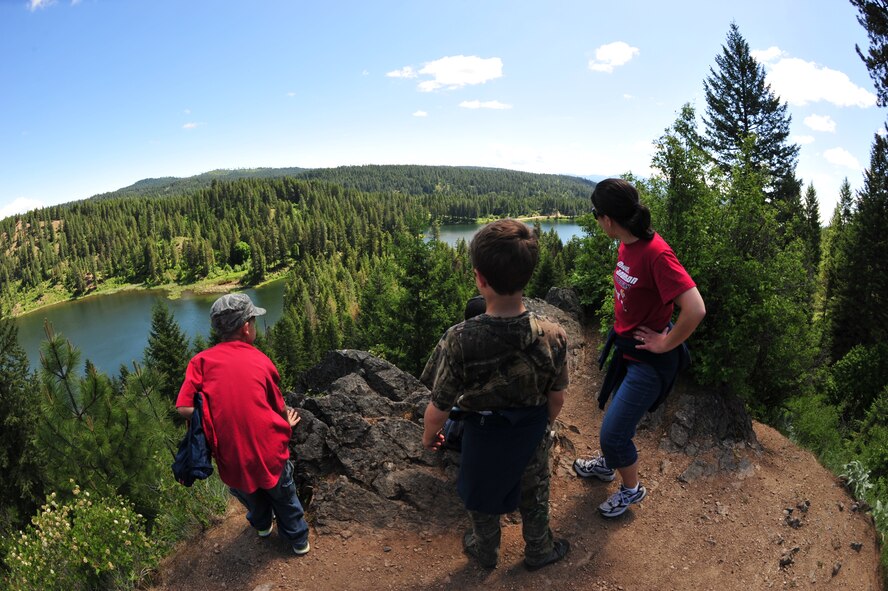 Melanie Kilgore, who is the learning specialist at Michael Anderson Elementary School, and three fourth graders from Michael Anderson, overlook the lake and forest at YMCA Camp Reed during a 50-minute hike May, 31, 2013. The hike was about 25 minutes up hill and 25 minutes downhill. This was Kilgore’s ninth year attending the annual camping trip. (U.S. Air Force photo by Senior Airman Earlandez Young/Released)   