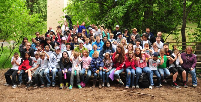 Michael Anderson Elementary School fourth graders along with teachers and camp counselors, make funny expressions for a group photo May 30, 2013, at YMCA Camp Reed, during Michael Anderson’s annual Camp Reed trip. Throughout the overnight campout, students performed activities such as art, science, wilderness survival, team building and more. (U.S. Air Force photo by Senior Airman Earlandez Young/Released)