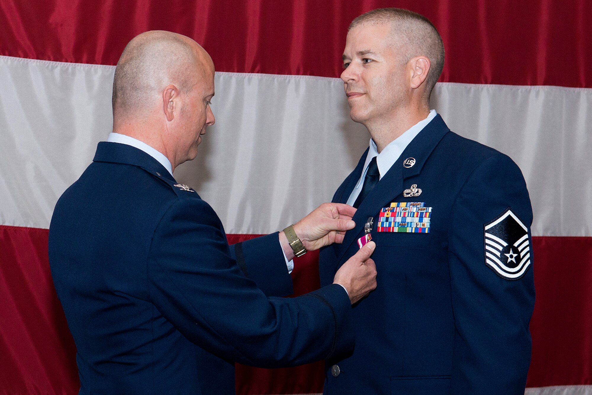 U.S. Air Force Col. Jonathan Ellis, 307th Bomb Wing commander, presents the Meritorious Service Medal to Master Sgt. John Donelson during a ceremony held on June 2, 2013, Barksdale Air Force Base, La. Donelson distinguished himself in performance of outstanding service to the United States while assigned to the 307th Maintenance Squadron. (U.S. Air Force photo by Master Sgt. Greg Steele/Released)