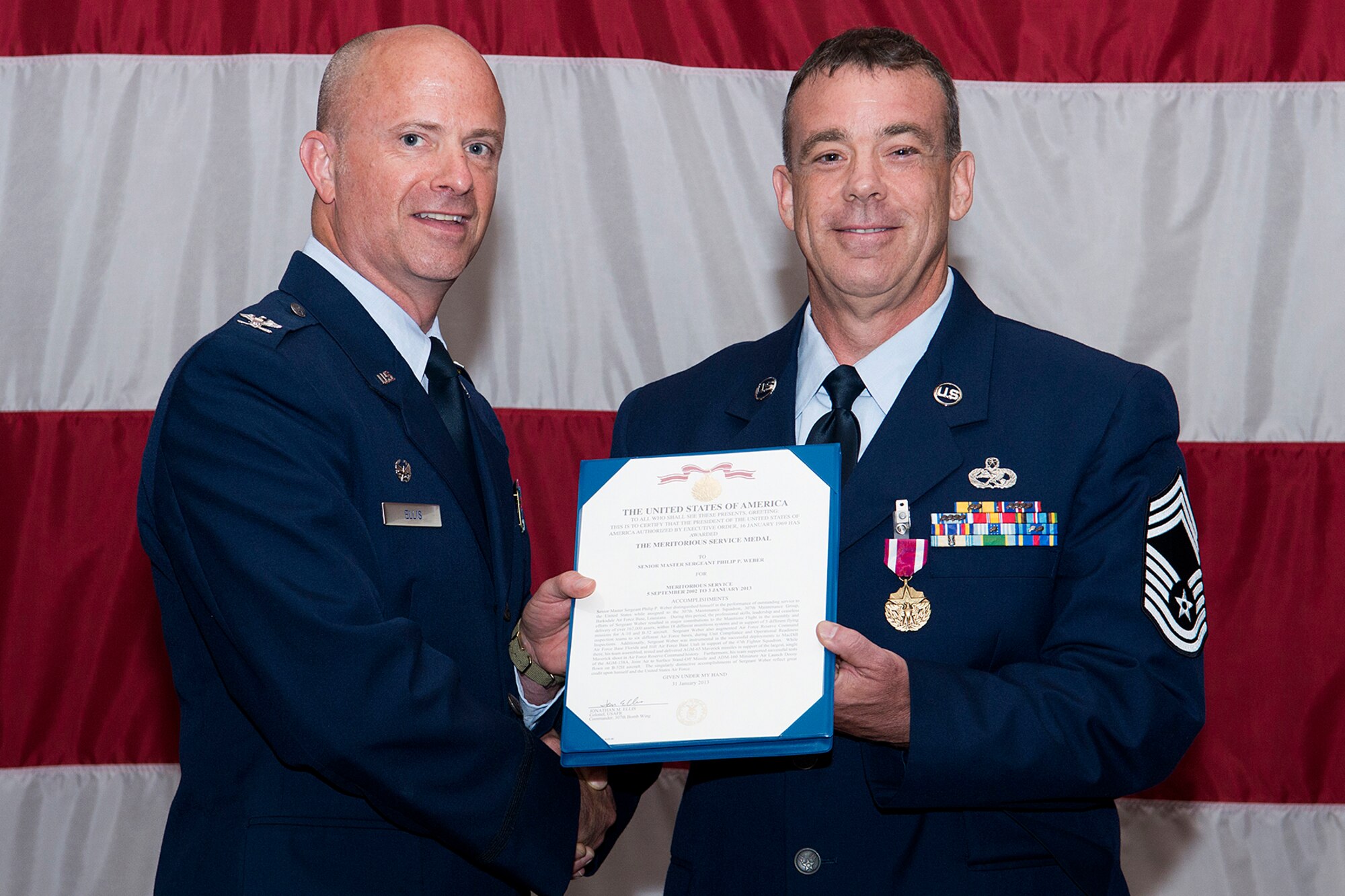 U.S. Air Force Col. Jonathan Ellis, 307th Bomb Wing commander, presents the Meritorious Service Medal to Chief Master Sgt. Philip Weber during a ceremony held on June 2, 2013, Barksdale Air Force Base, La. Weber distinguished himself in the performance of outstanding service to the United States while assigned to the 307th Maintenance Squadron. (U.S. Air Force photo by Master Sgt. Greg Steele/Released)