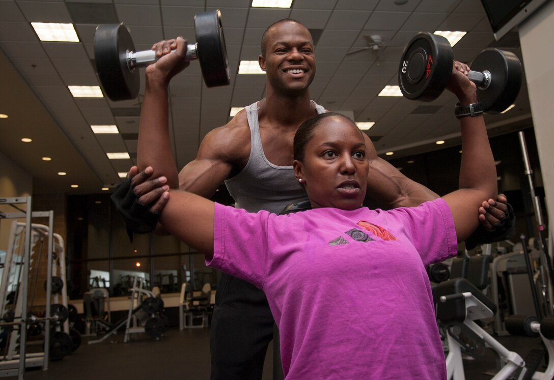 Staff Sgt. Robert Niter III, 47th Medical Operations Squadron NCO in charge of optometry, spots 1st Lt. Fiona Pham, 47th Logistics Readiness Division operations officer, at Laughlin Air Force Base, Texas, May 29, 2013. Niter not only keeps himself in top physical form, but also mentors and helps other Airmen reach their fitness goals. (U.S. Air Force photo/Airman 1st Class John D. Partlow)