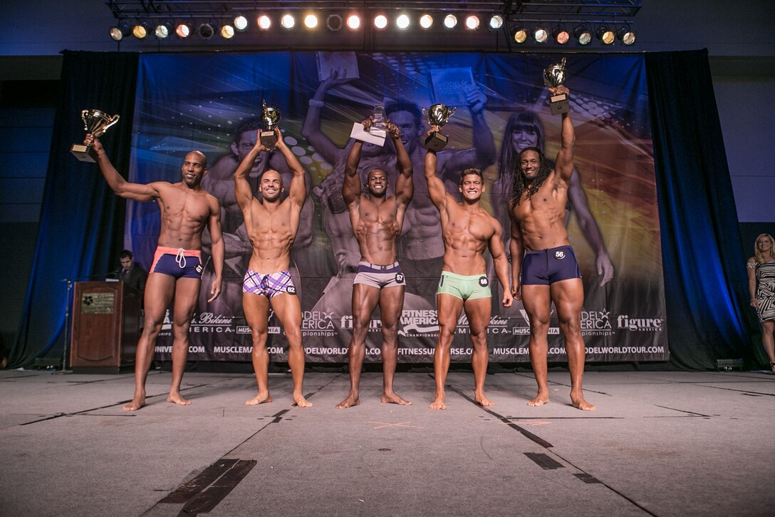 Competitors stand on stage after receiving their awards in the Musclemania Lone Star pro show Galveston, Texas, May 18, 2013. Staff Sgt. Robert Niter II, 47th Medical Operations Squadron NCO in charge of optometry, won first place overall in the physique competition. (Courtesy photo/James Allen)