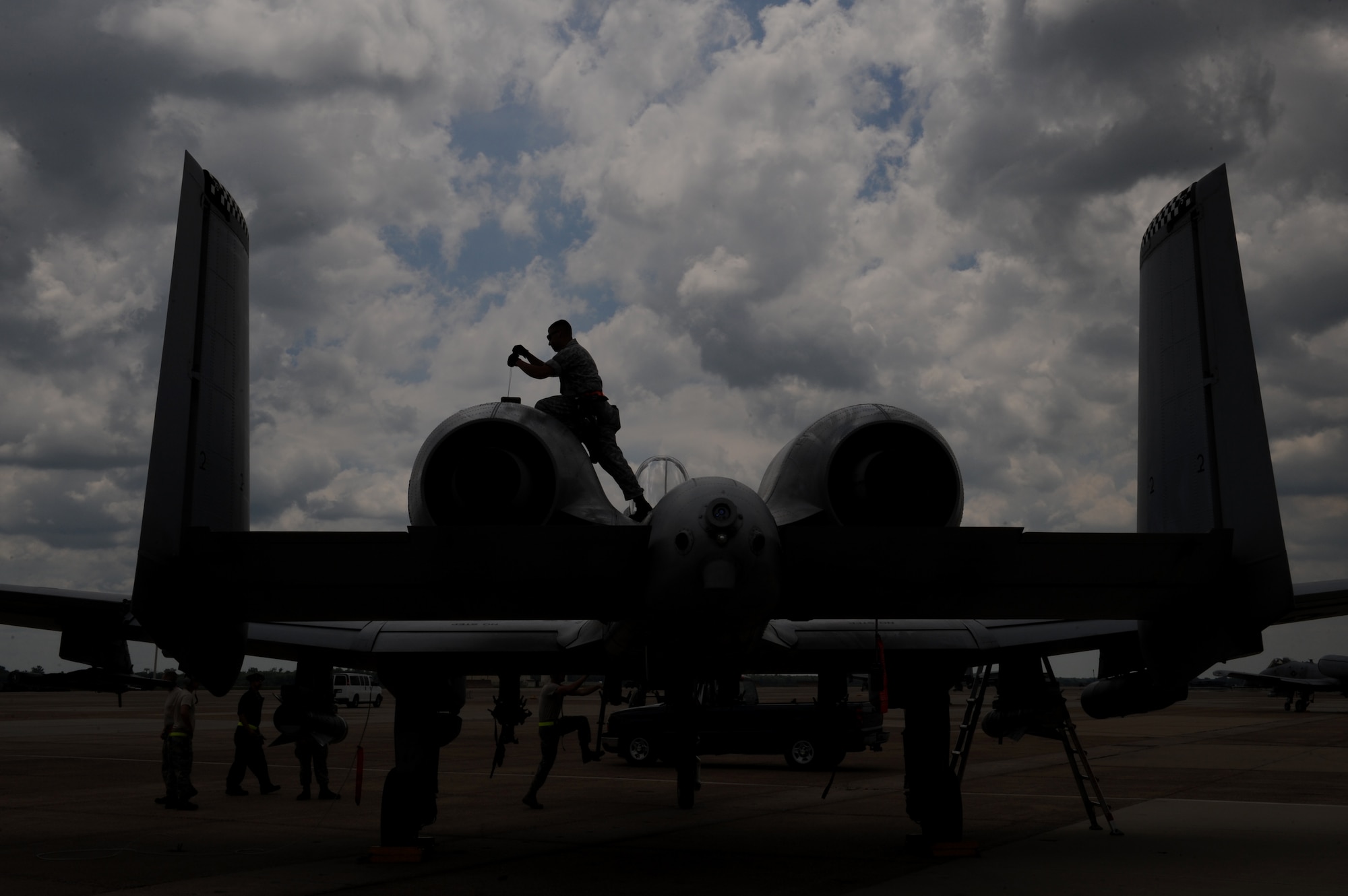 Senior Airman Jason Norris, a crew chief from Moody Air Force Base, Ga., conducts a joint oil analysis on an A-10 Thunderbolt II fighter on Barksdale Air Force Base, La., June 4, 2013. Crew chiefs must check the oil inside the engine 15 minutes after landing for metal shavings. If there is a certain concentration of metal shavings inside the oil, maintainers must find and fix the source of the problem. (U.S. Air Force photo/Airman 1st Class Benjamin Gonsier)