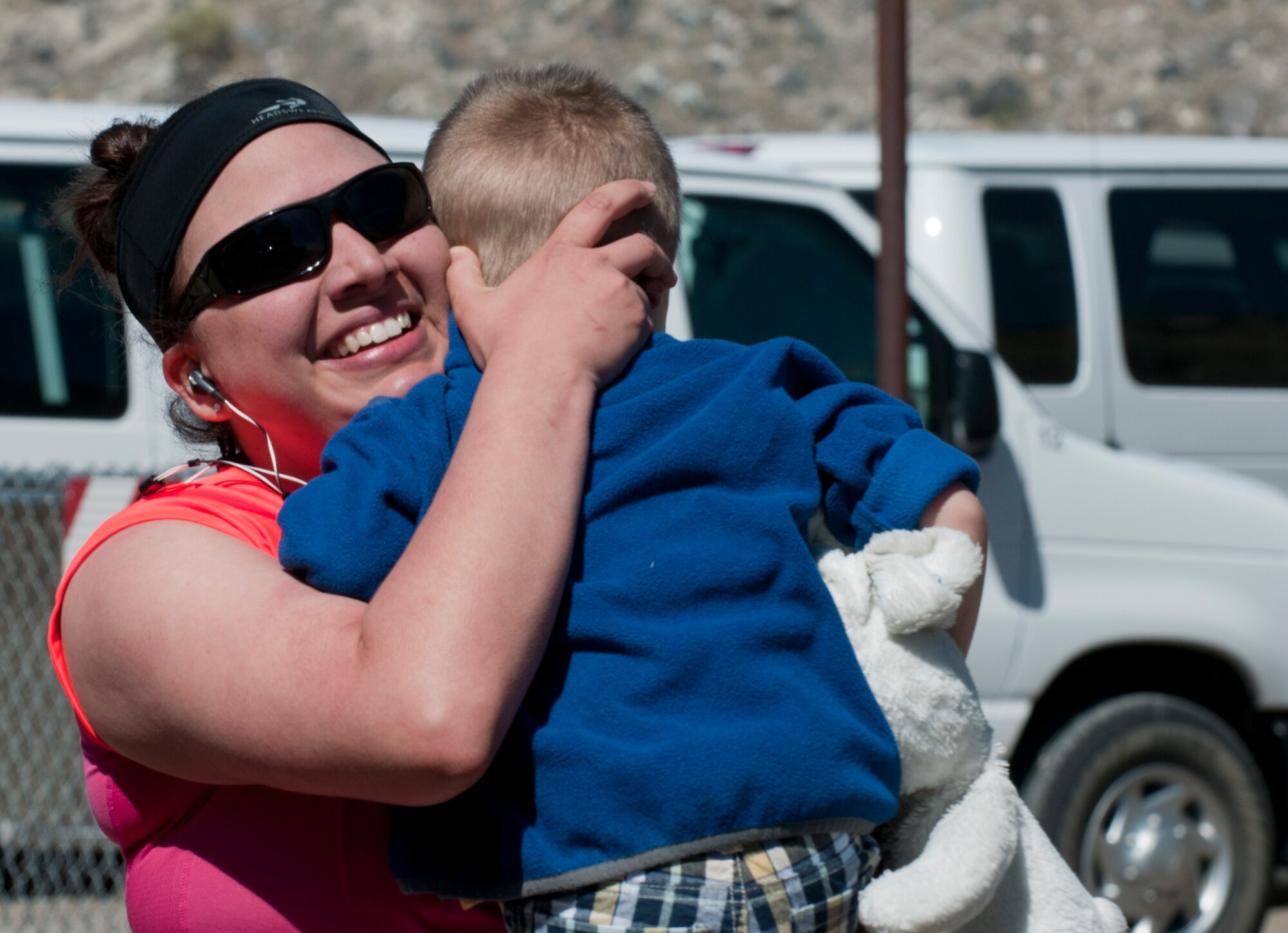 U.S. Air Force Staff Sgt. Evon Pretulak, 366th Fighter Wing Equal Opportunity director, hugs her son after completing the second annual Gunfighter Stampede half marathon June 1, 2013, at Strike Marina, Bruneau, Idaho. Pretulak beat her two personal goals for the run and finished with a time of 2:57:17. (U.S. Air Force photo by Senior Airman Heather Hayward/Released)