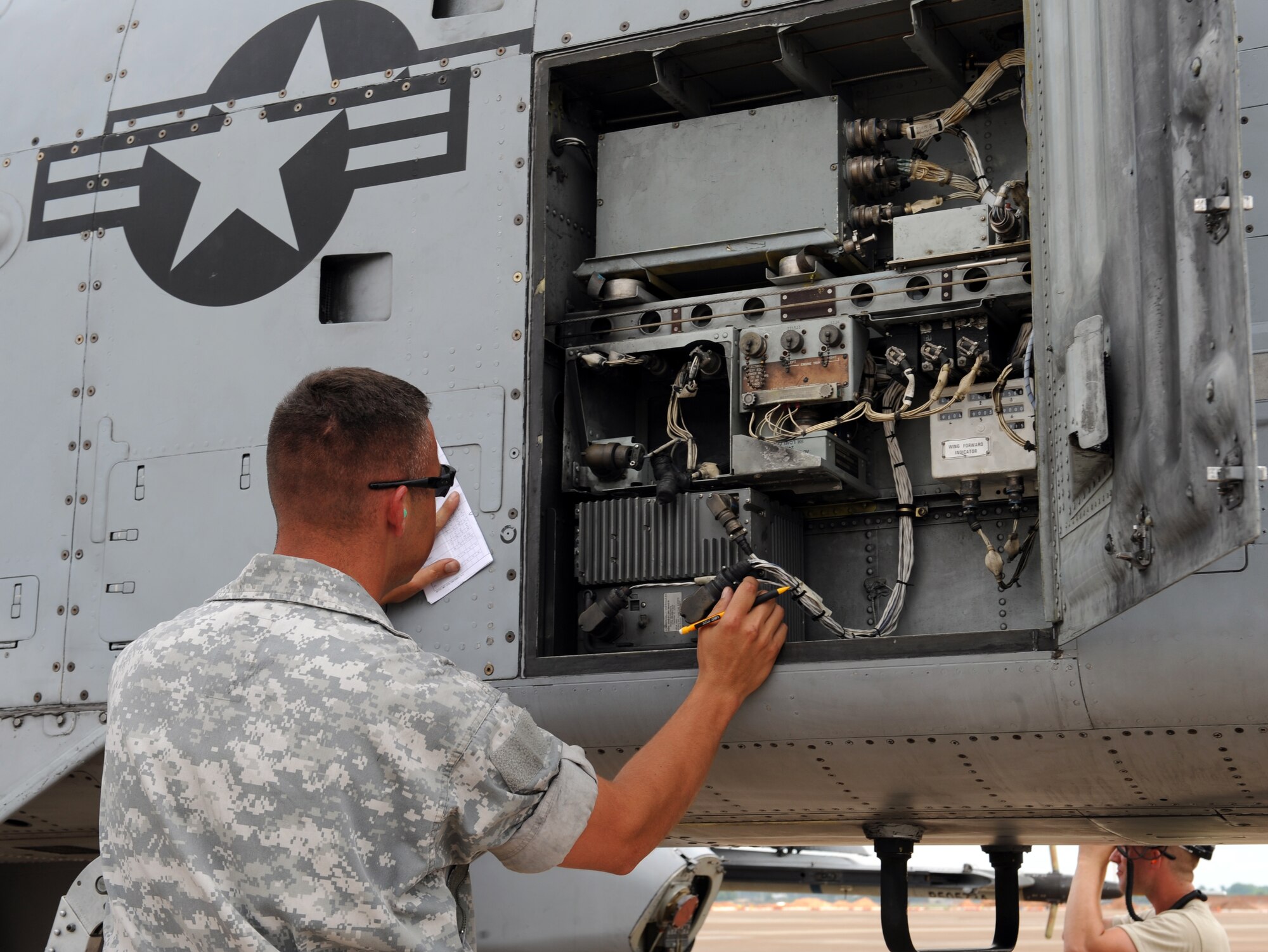 Senior Airman Jason Norris, a crew chief from Moody Air Force Base, Ga., ensures wires inside an A-10 Thunderbolt II fighter are functioning properly after flight on Barksdale Air Force Base, La., June 4, 2013. The Airmen, from Moody, are participating in the exercise Green Flag East. The exercise trains Airmen from different career fields to work together and prepare for deployments to combat environments. (U.S. Air Force photo/Airman 1st Class Benjamin Gonsier)
