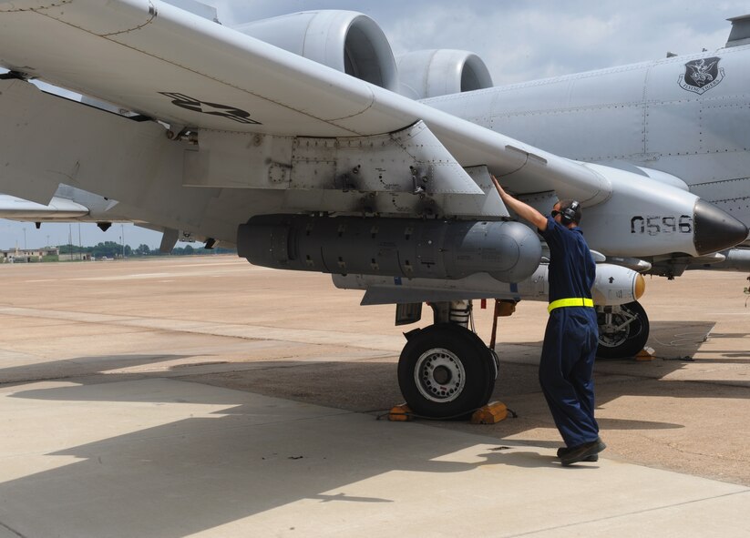 A crew chief from Moody Air Force Base, Ga., checks the wing of an A-10 Thunderbolt II fighter for discrepancies on Barksdale Air Force Base, La., June 4, 2013. During flight, nuts and bolts come loose because of vibrations from the plane. Crew chiefs must ensure all nuts and bolts are tightened or replaced after flight. (U.S. Air Force photo/Airman 1st Class Benjamin Gonsier)