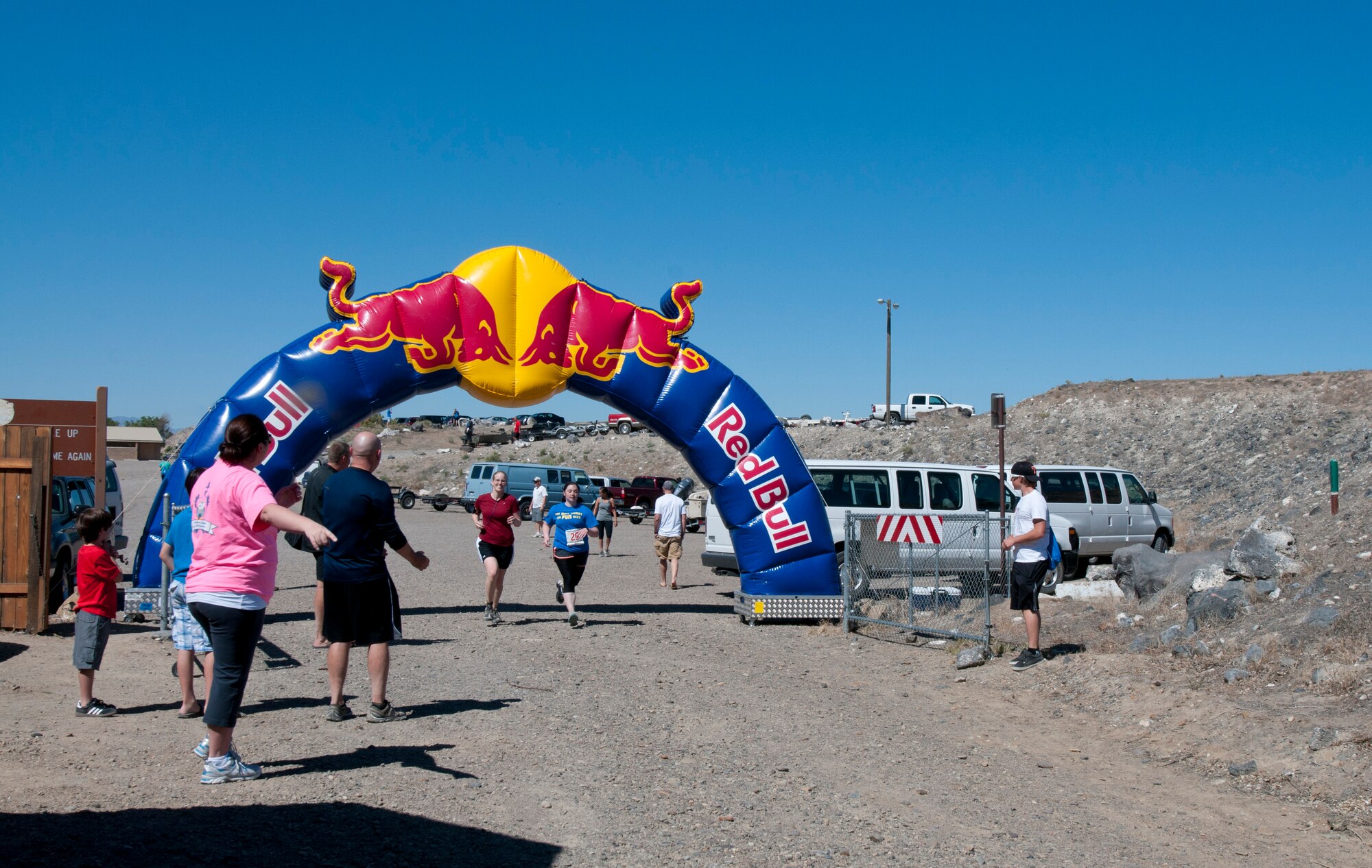 Spectators cheer for runners as they cross the finish line after completing the second annual Gunfighter Stampede half marathon June 1, 2013, at Strike Marina, Bruneau, Idaho. The run was cross-country and took the participants through rough terrain, several hills and dirt roads. (U.S. Air Force photo by Senior Airman Heather Hayward/Released)