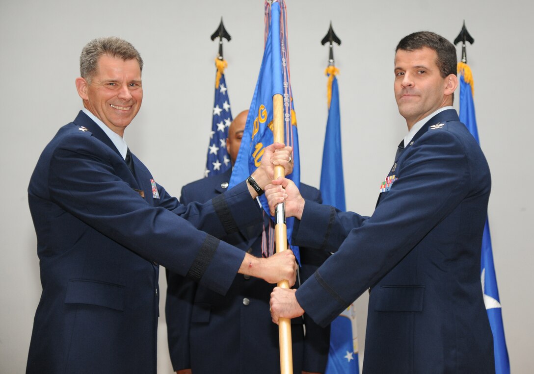 Upon receiving the guidon, Maj. Gen. Gerard Caron, 79th Medical Wing commander, passed it to Col. (Dr.) Thomas J. Cantilina who assumed command of the 779th Medical Group at a change of command ceremony on June 5, 2013 at Joint Base Andrews, Md.  Cantilina will have primary responsibility for 1,356 Airmen and civilians operating in four locations to include Malcolm Grow Medical Clinic and Surgery Center. They provide health service support to Joint Base Andrews, primary health care to 30,000 enrolled beneficiaries, and specialty health care to over 600,000 Department of Defense beneficiaries in the National Capital Region. He also has oversight of a 45-bed aeromedical staging facility that serves as the aeromedical evacuation hub for the East Coast, receiving wounded, ill, and injured warriors back to the continental United States. (Air Force Photo by A1C Aaron Stout)