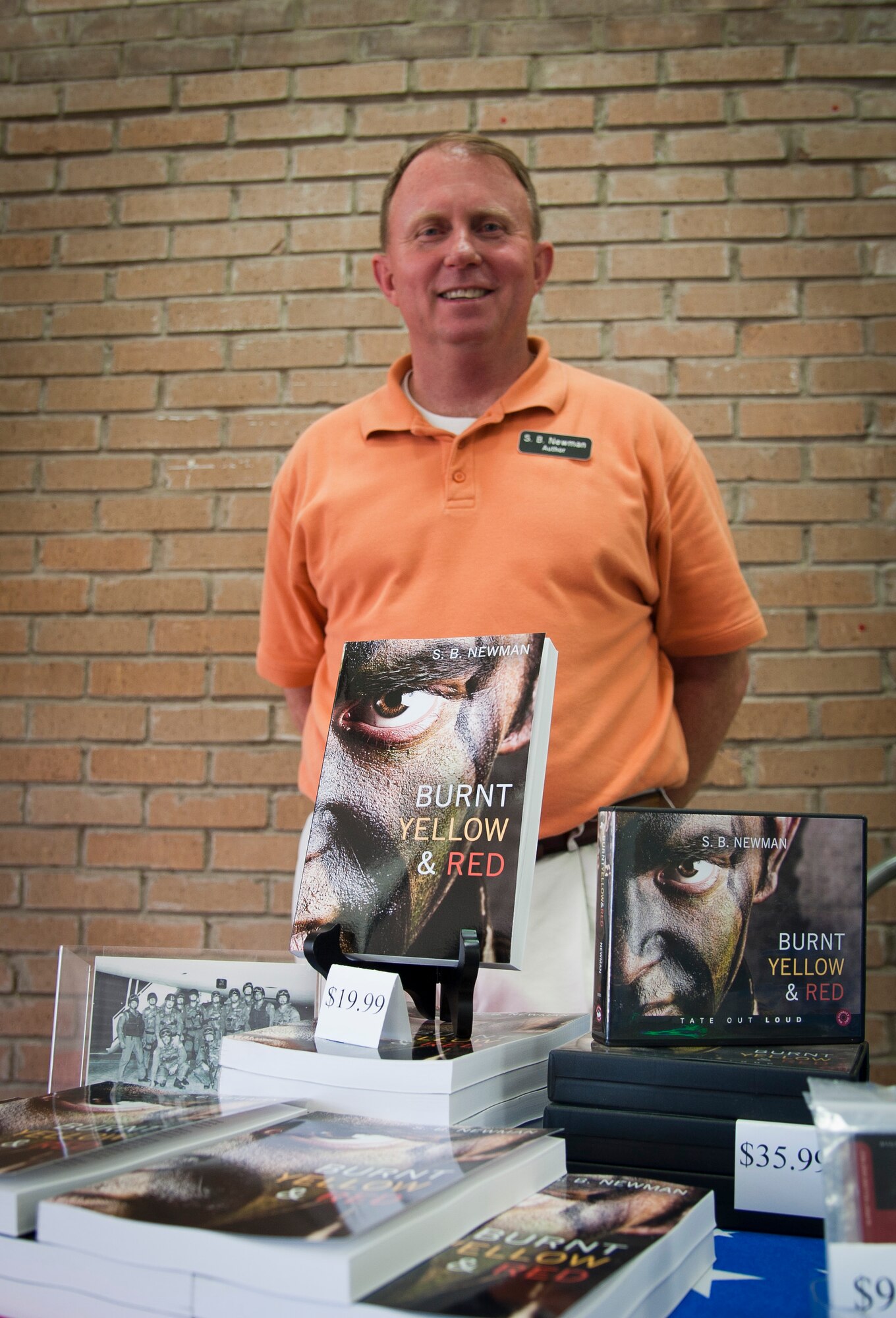Retired Army Master Sgt. Steve Newman poses in front of his recently published historical fiction novel “Burnt Yellow and Red” on June 4, 2013.  Newman is signing his two novels “The Night Eagles Soared” and “Burnt Yellow and Red” until June 9 at the base exchange.