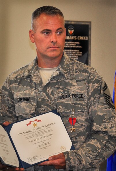 Senior Master Sgt. Jamie Jordan, 33rd Aircraft Maintenance Squadron assistant superintendent, receives the Bronze Star during an official ceremony at his unit June 4, 2013. While deployed from March 2012 to February 2013, Jordan was a group maintenance superintendent leading a team that generated more than 8,000 combat missions and the collection of 250,000 intelligence images supporting U.S. Central Command combat operations in the Horn of Africa. (U.S. Air Force photo/Chrissy Cuttita) 