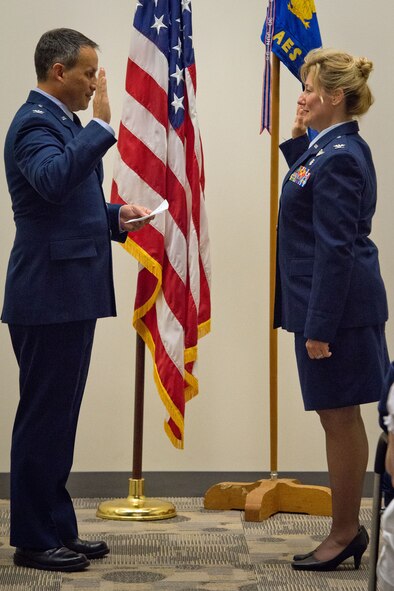 Col. Todd McCubbin, 934th Airlift Wing vice commander, reads the promotional order to Col. Sherry Hemby, 934th Aeromedical Evacuation Squadron commander, during her promotion ceremony at the Minneapolis-St. Paul Air Reserve Station, Minn. (U.S. Air Force photo/Staff Sgt. Samantha Wagner)
