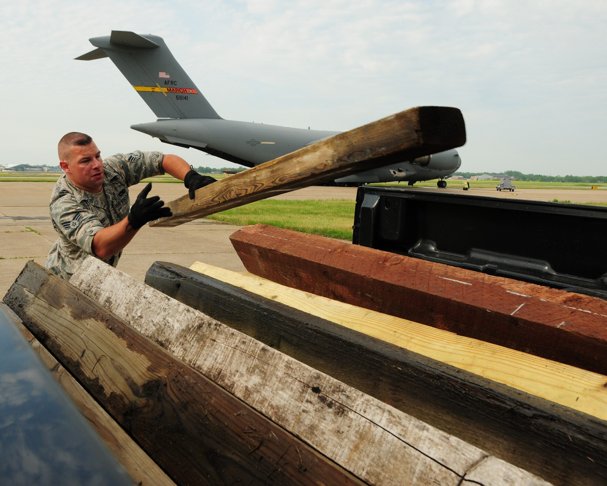 Senior Airman Francesco Torcasio, 30th Aerial Port Squadron ramp specialist, loads dunnage on the back of a pickup at the Niagara Falls Air Reserve Station, N.Y. on May 29, 2013. The dunnage was used to support pallets onboard a 452nd Air Mobility Wing C-17 aircraft. Eleven pallets of locally donated civilian firefighting equipment and an ambulance were all part of a Denton Cargo training flight bound for the Dominican Republic. (U.S. Air Force photo by Peter Borys)