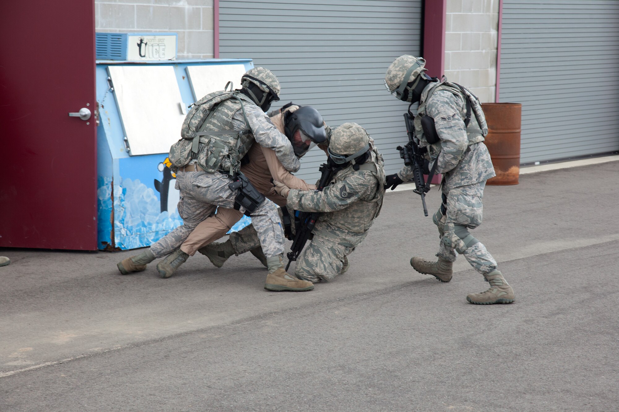 Members of the 934th Security Forces Squadron subdue a suspect during a training exercise.  The exercise May 31 at Camp Ripley, Minn. emphasiszed building clearing and hands on military tactics.  (U.S. Air Force photo/Shannon McKay)